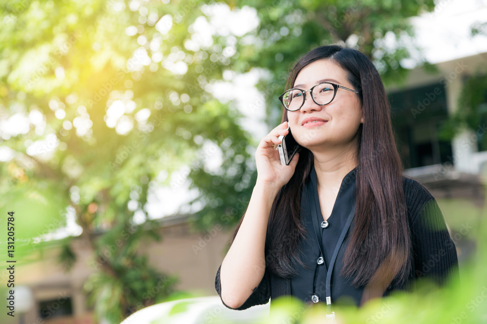 Happy asian glasses woman use to talking on smart phone outdoor Happy asian glasses woman use to talking on smart phone outdoor