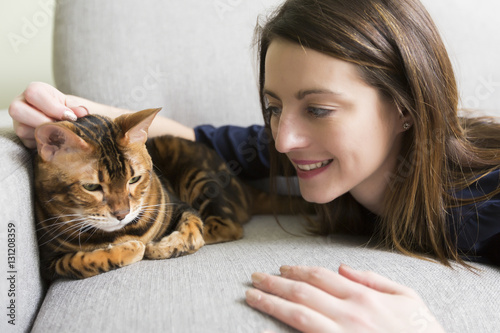 Cat and woman in the living room on the couch photo