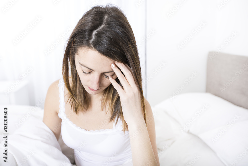 Young sleeping woman in bedroom at home wearing in white Young sleeping woman in bedroom at home wearing in white