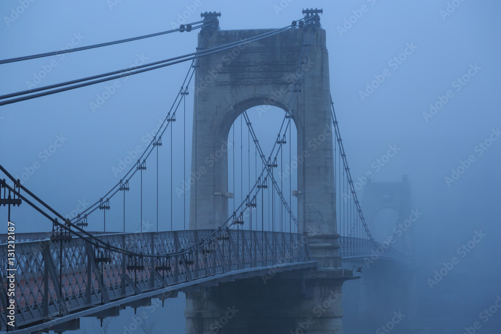 Fog at Passerelle du College bridge over the Rhone river in Lyon, on an autumn morning.