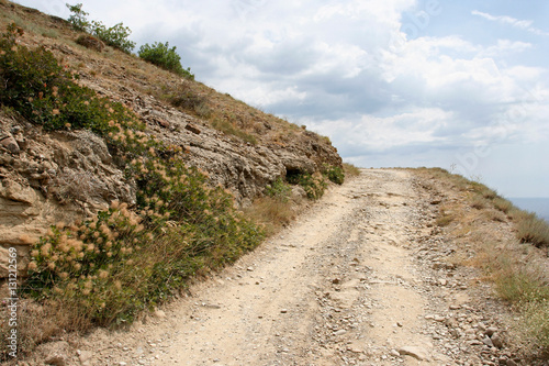 The landscape with the earth road on the hillside. This photo was taken on the Meganom cape in Crimea.