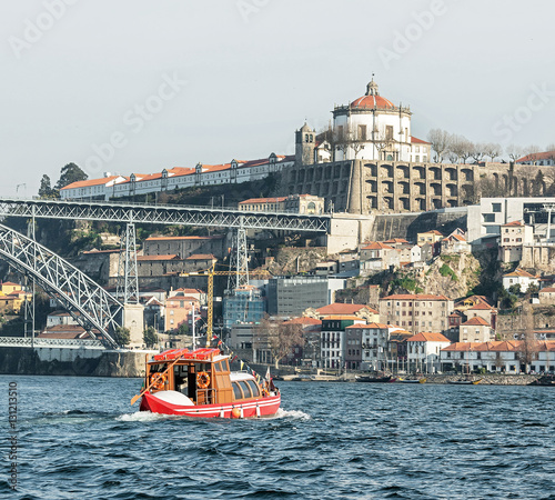 River Douro and red pleasure boat - Porto, Portugal photo