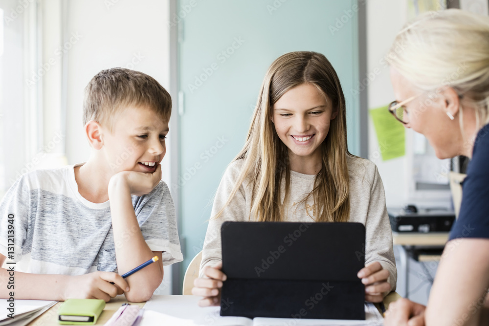 Teacher with pupils using tablet