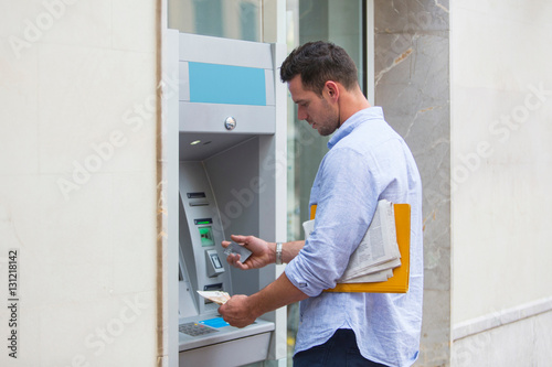 Wallpaper Mural Man withdrawing cash from cash machine Torontodigital.ca