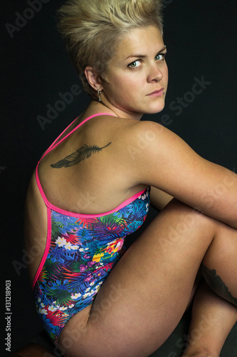 photo portrait short hair light hair girl posing in swimsuit gray background © alien_zagrebelna