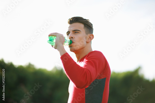 Portrait of man drinking from water bottle