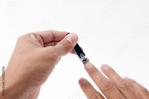 Nail clipper in hand on white background.
