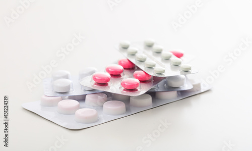 Stack of pills on white background