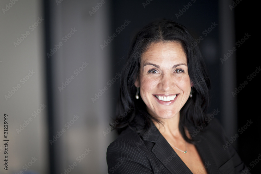 Mature Spanish Businesswoman Smiling At The Camera. At The Office. Mature Spanish Businesswoman Smiling At The Camera. At The Office.