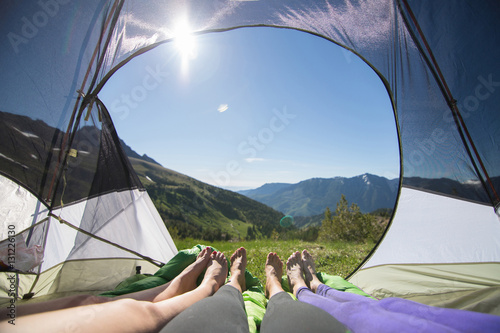Hikers resting inside tent, Enchantments, Alpine Lakes Wilderness, Washington, USA