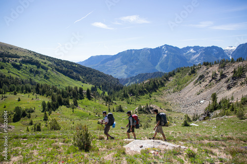 Hikers walking across valley, Enchantments, Alpine Lakes Wilderness, Washington, USA