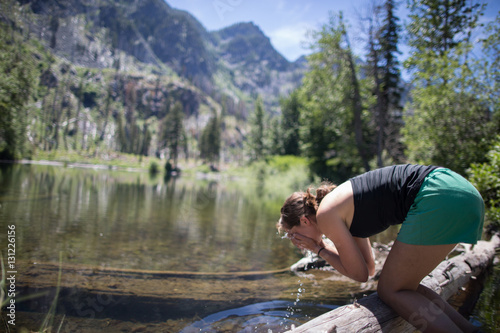 Hiker washing face in stream, Enchantments, Alpine Lakes Wilderness, Washington, USA