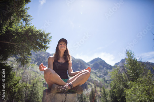 Hiker practising yoga on tree stump, Enchantments, Alpine Lakes Wilderness, Washington, USA
