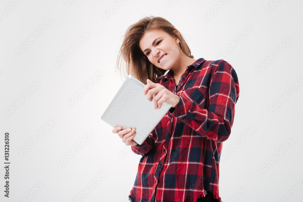 Portrait of a young excited girl using tablet computer Portrait of a young excited girl using tablet computer