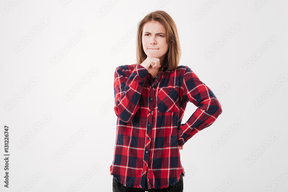 Thougtful pretty brunette girl in plaid shirt thinking about something Thougtful pretty brunette girl in plaid shirt thinking about something