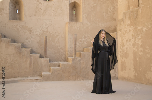 Woman in abaya in Jabreen castle, Oman photo