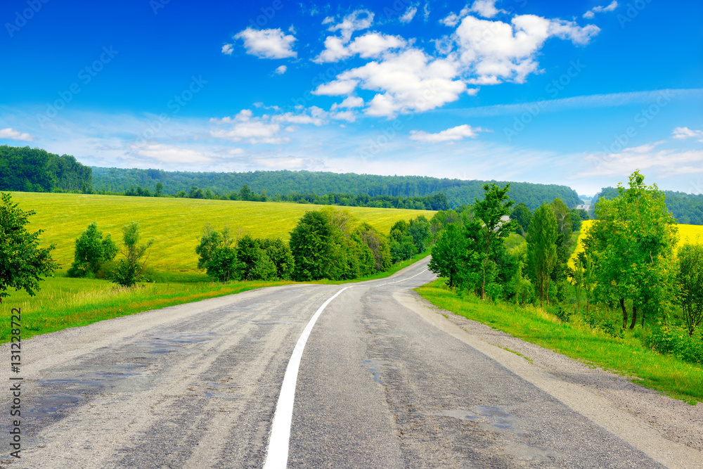 Rural paved road among fields and beautiful sky Rural paved road among fields and beautiful sky