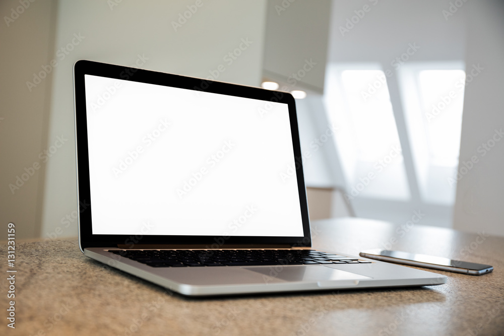 Fototapeta premium Laptop and phone on a table. Flat. Apartment. High definition photo.