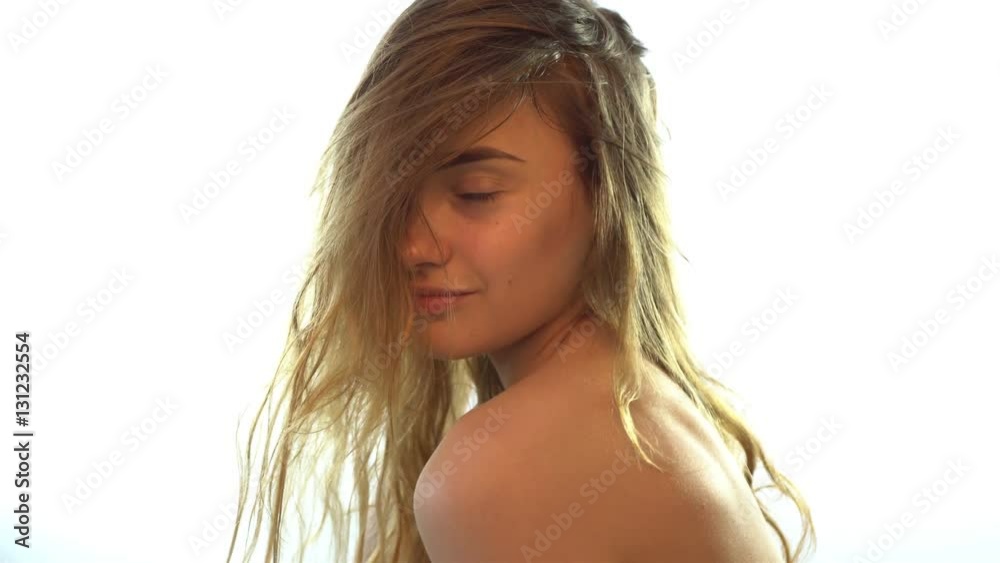 beautiful nude girl with wet hair looks forward and smiles beautiful nude girl with wet hair looks forward and smiles