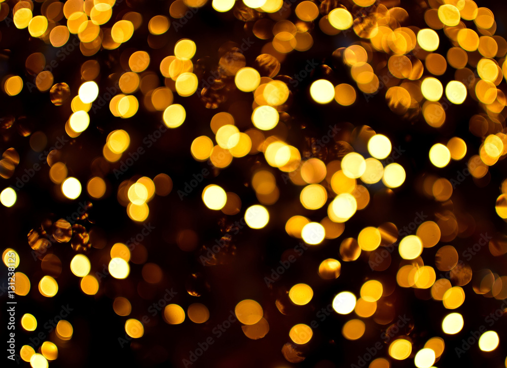 Gold bokeh light. Christmas background. Xmas tree blur lights for greeting card.