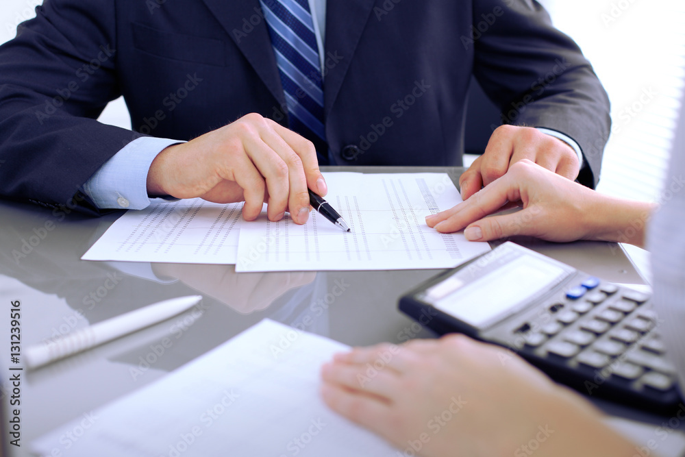Bookkeepers or financial inspector making report, calculating or checking balance. Audit concept. Bookkeepers or financial inspector making report, calculating or checking balance. Audit concept.