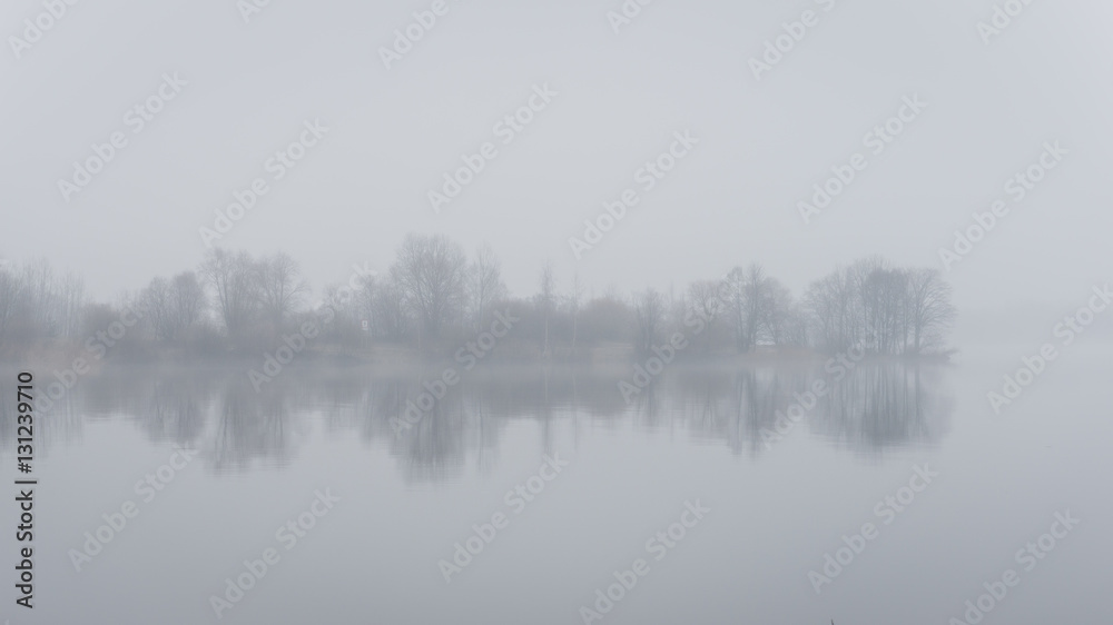Fototapeta premium heavy mist over the river in autumn
