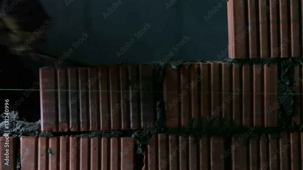 builders lays bricks on a construction site builders lays bricks on a construction site