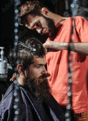 Barber cuts hair to man