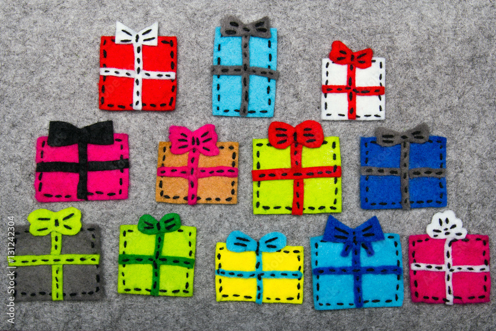 Obraz premium Christmas gifts on grey background. Felt Christmas ornaments with copy space