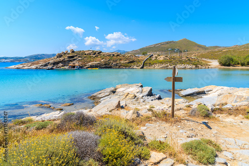 Fototapeta Naklejka Na Ścianę i Meble -  Beautiful coastal path along crystal clear sea water in Monastiri bay on Paros island, Greece