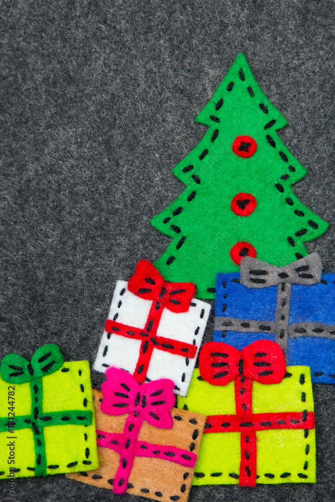 Christmas tree and colorful gifts on grey background.  Felt Christmas ornaments with copy space