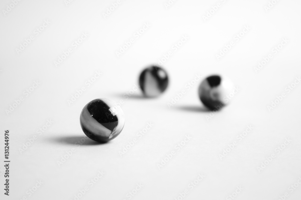 Three Black and White Marbles