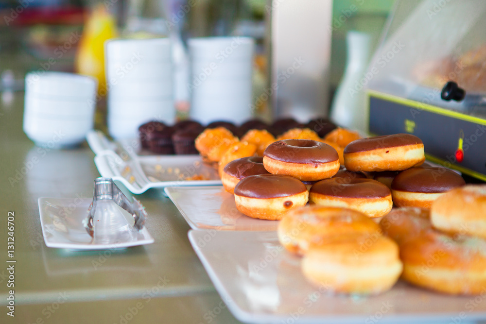 Different sorts of donats on breakfast in cafe Different sorts of donats on breakfast in cafe
