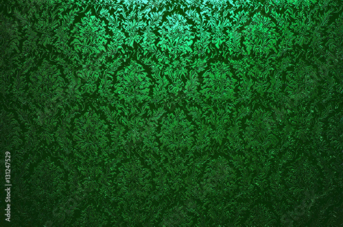 Fragment of ornamental wallpaper green navy turqoise  colored , or abstract surface of tiled flowers and leaves  pattern, or texture useful as a background vignetted and gradient background 