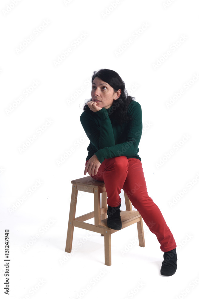 Fototapeta premium Portrait of a woman sitting with white background
