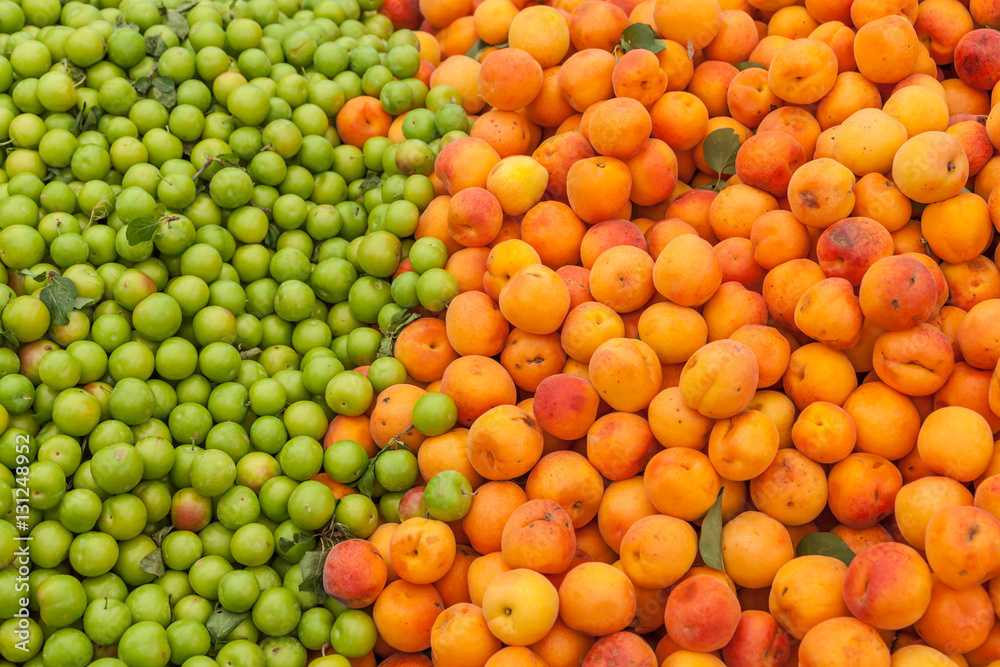 Green plums and apricots at the farmers market