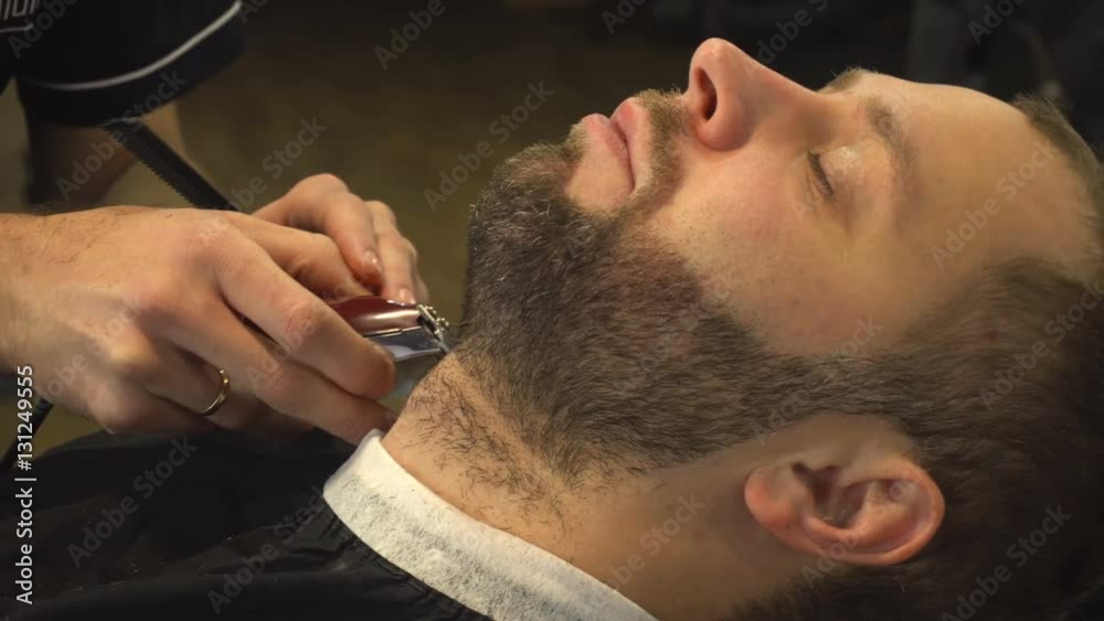 Shaving beard of man in barber shop Shaving beard of man in barber shop