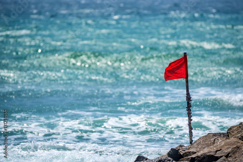 Red warning flag on beach