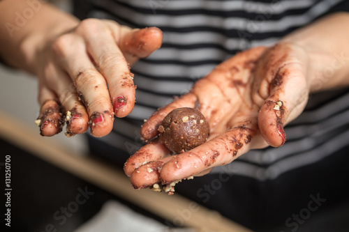 Woman rolling homemade chocolate truffles in her hands