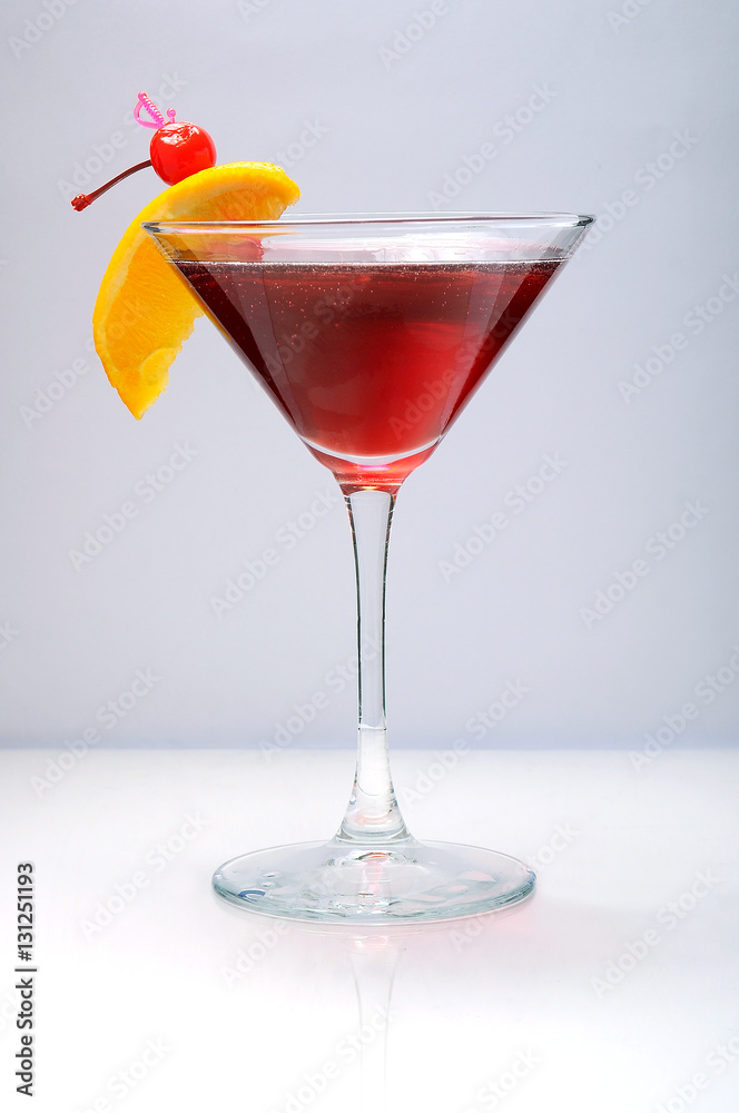 Alcohol cocktail with orange and cherry decoration