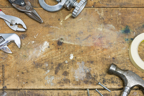 Authentic worn workshop bench background with various tools