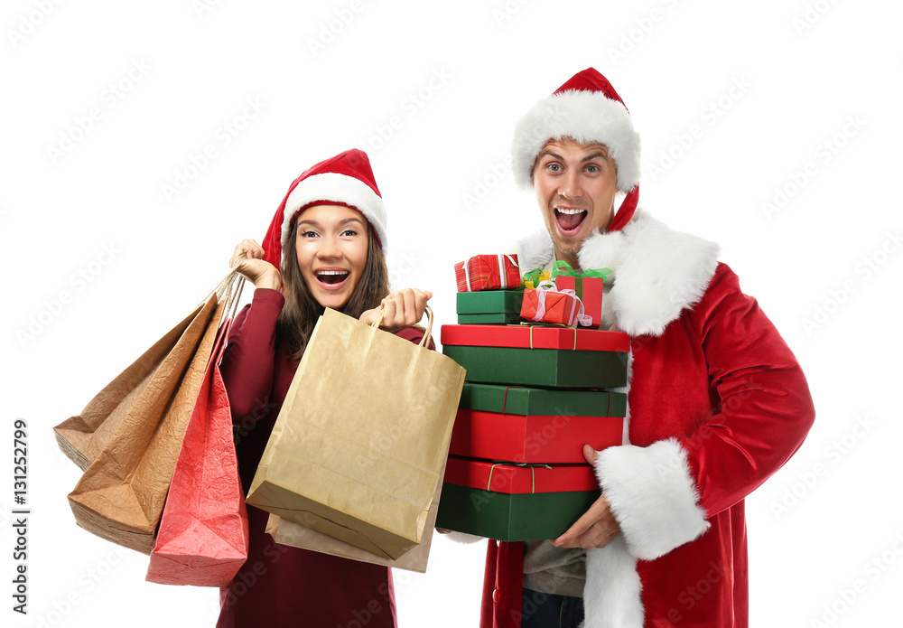 Young couple with Christmas purchases on white background Young couple with Christmas purchases on white background