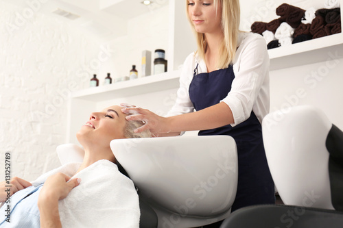 Hairdresser washing woman's...