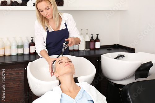 Hairdresser washing woman's...