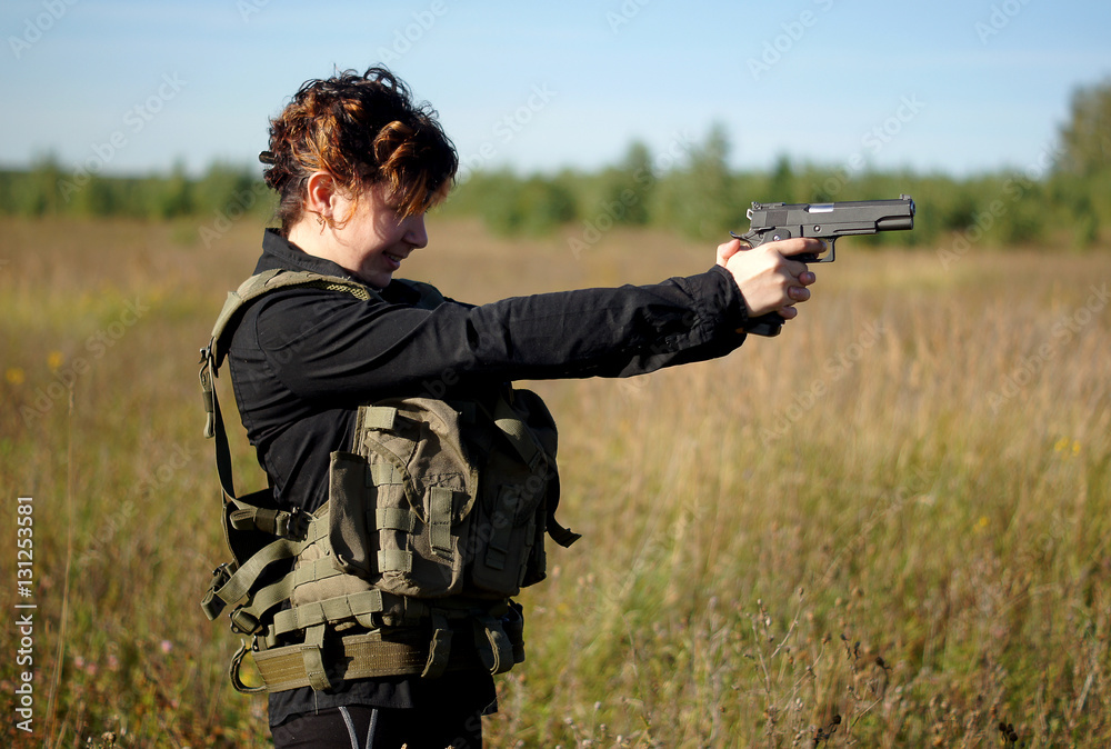 A girl with a gun in his hands A girl with a gun in his hands