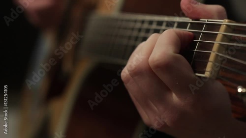 playing on the acoustic guitar. Musical instrument with guitarist hands