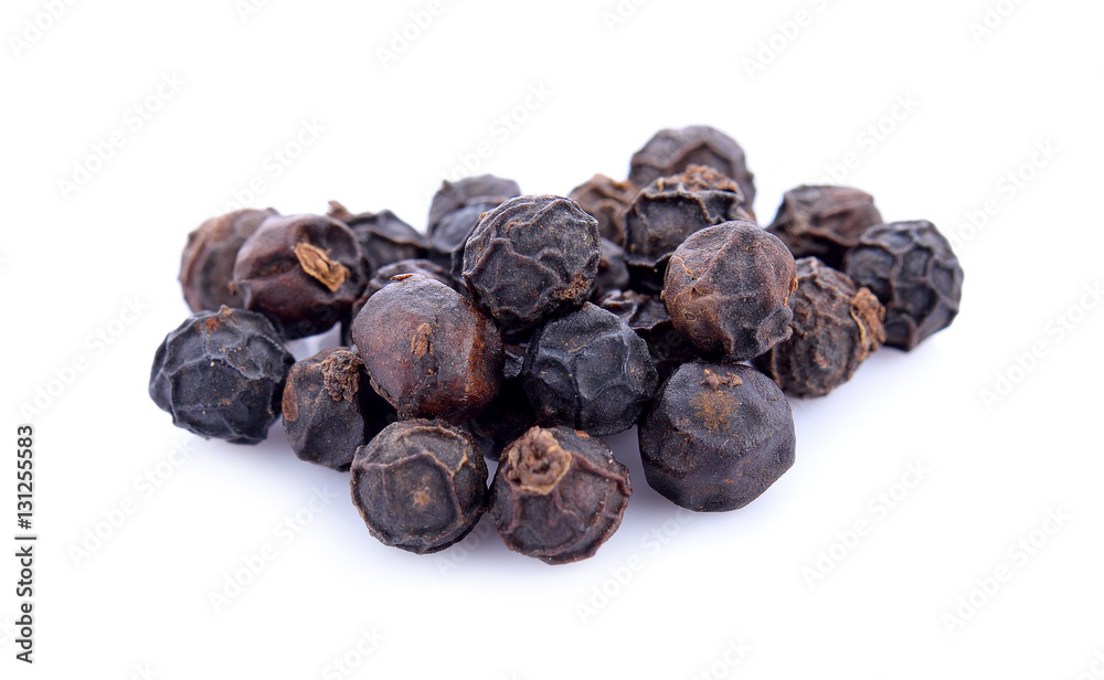 Black peppercorns isolated on white background. Overhead view. Black peppercorns isolated on white background. Overhead view.
