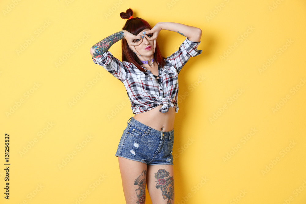 Beautiful girl with tattoo on color background Beautiful girl with tattoo on color background