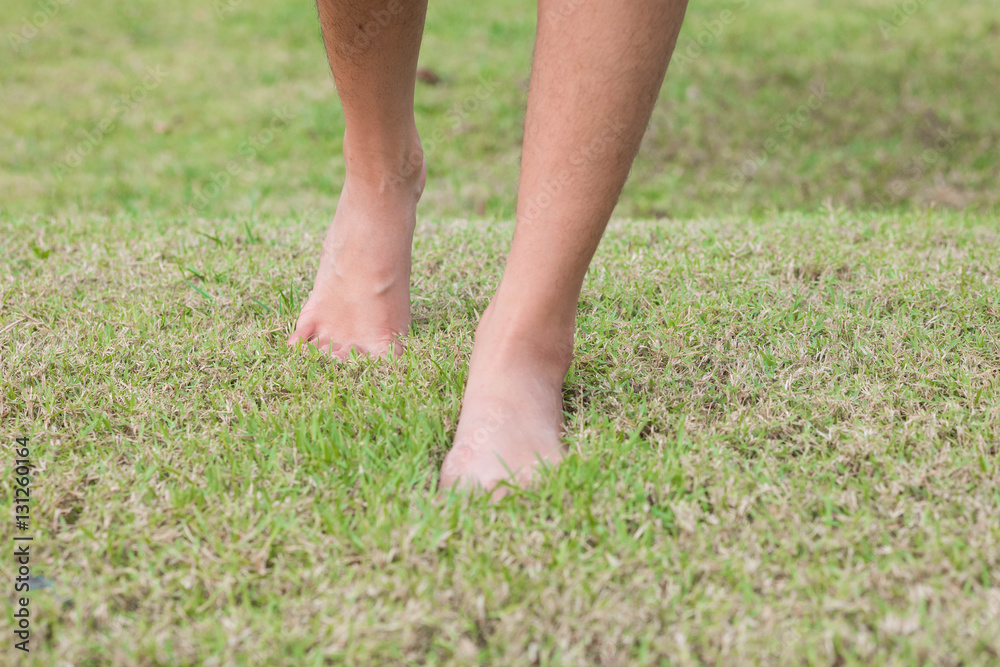 girl barefoot on grass,soft focus