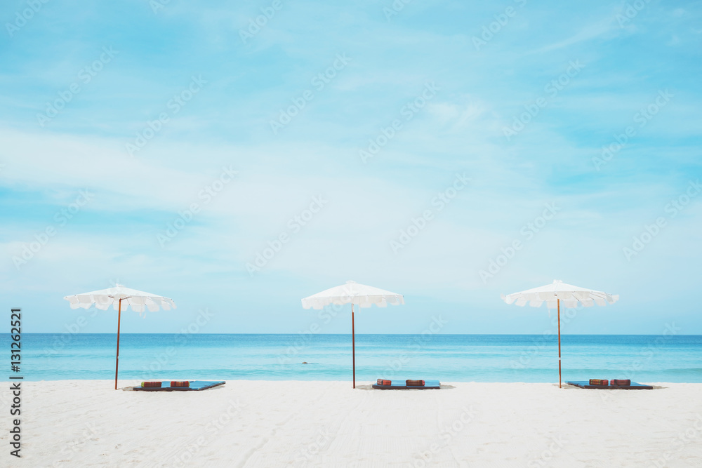 beach chairs on the white sand beach and blue sea